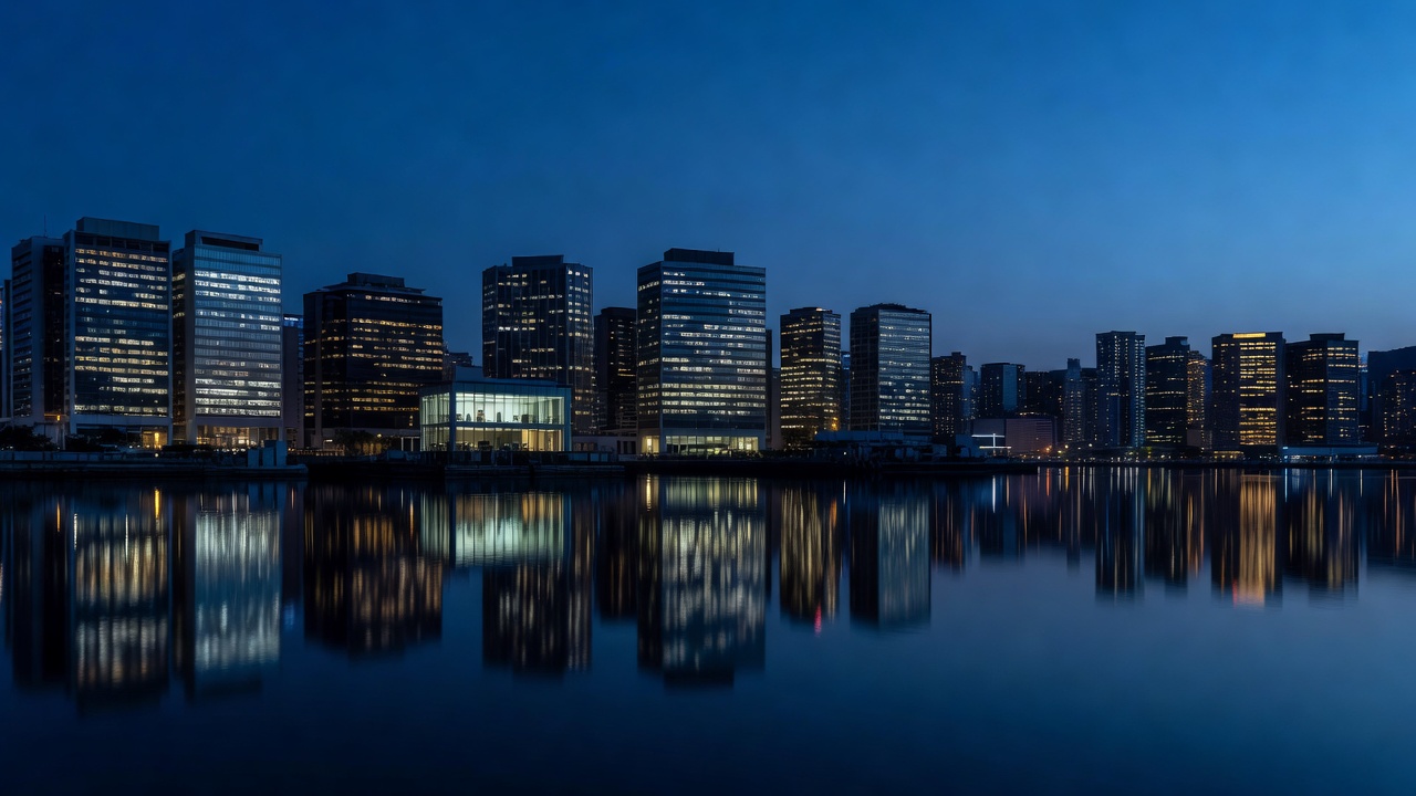 Wide shot of Hong Kong harbor at blue hour, illuminated office towers reflected in still water, a single lit boardroom visible mid-rise among glowing windows, cityscape silhouette against deep indigo sky, architectural photography, shot on 35mm lens, f/4, ambient blue-hour light